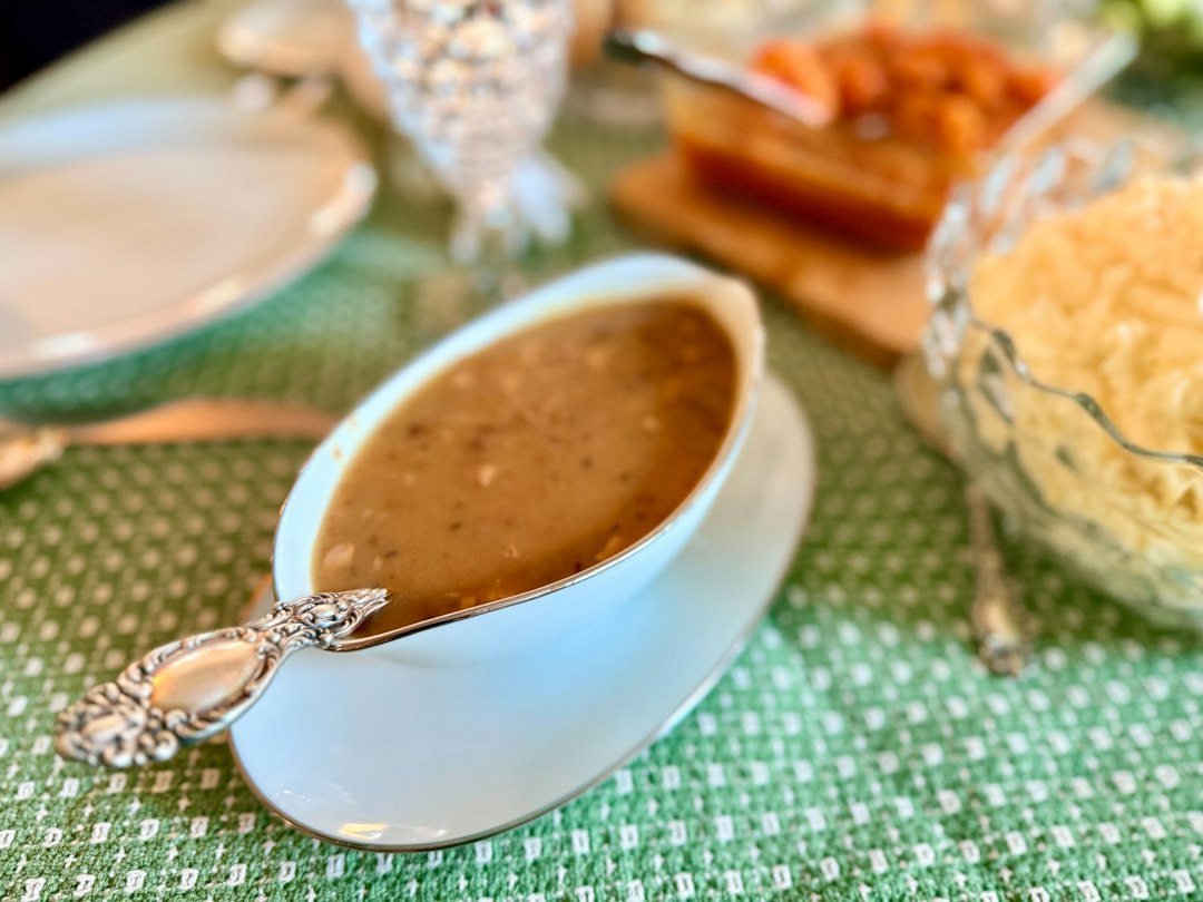 Brown gravy in a serving boat ready to accompany a roast dinner
