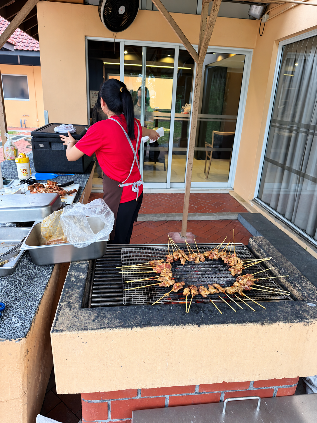 Satay skewers cooking on the charcoal grill during De’Vour NSRCC BBQ service