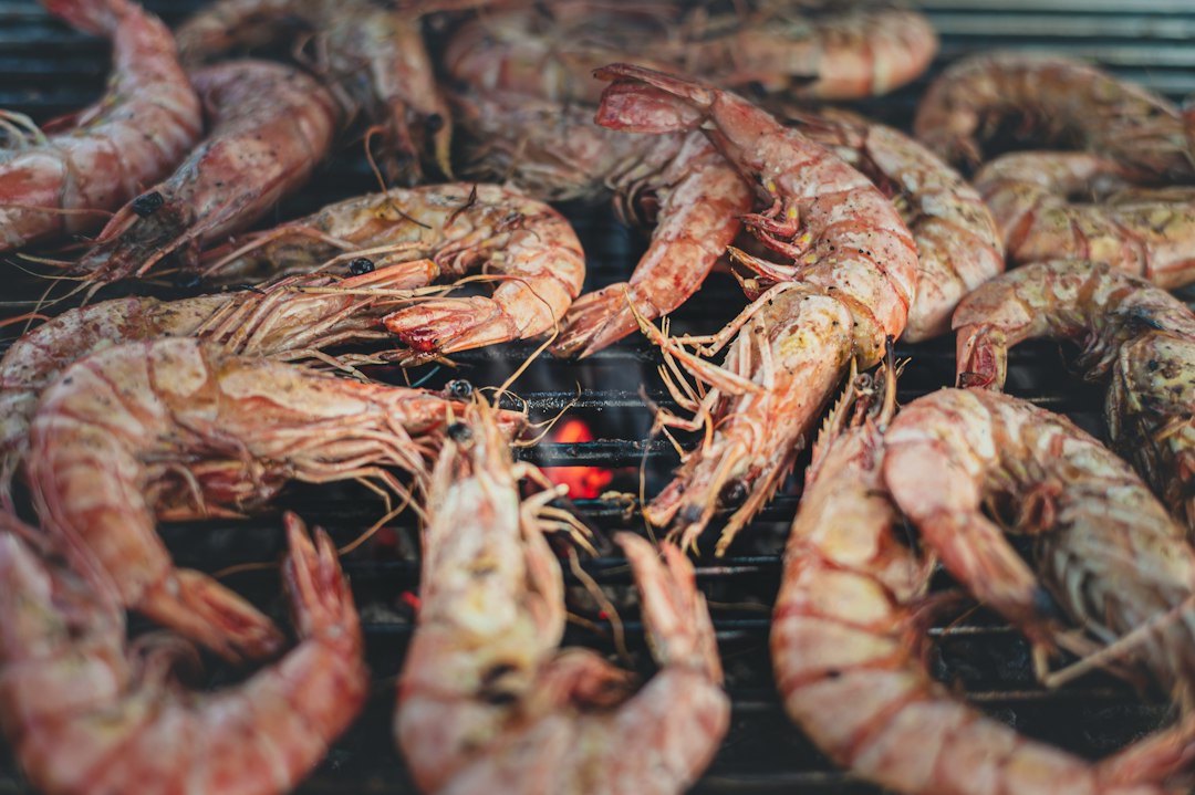 Prawns cooking on a BBQ grill as part of a seafood grilling guide