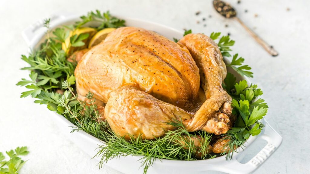 Wide festive roast turkey platter with herbs for Christmas dinner